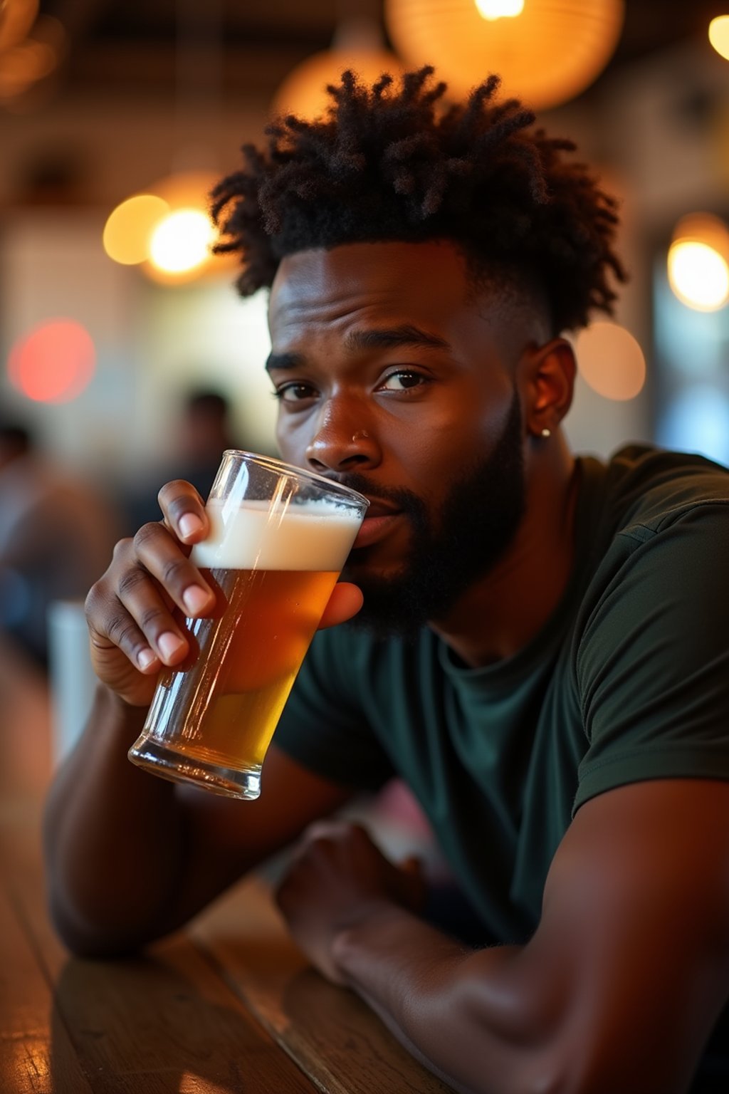 man in a busy bar drinking beer. holding an intact pint glass mug of beer