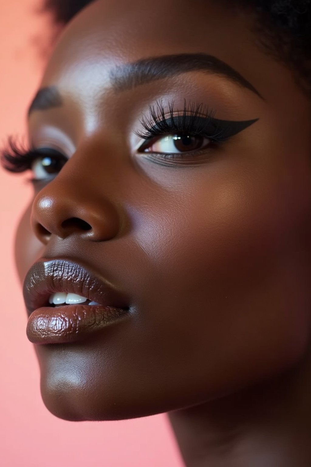 close-up of Model sporting winged eyeliner and matte skin finish. set against a soft, pastel background