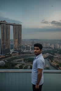 smiling man in Singapore with Marina Bay Sands in background