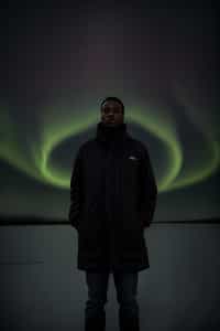 man at night at the Northern Lights Aurora Borealis