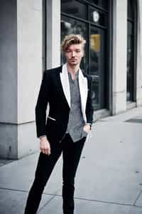 a confident ifgender=m{masculine} ifgender=f{feminine} man dressed in stylish attire, striking a pose in a trendy urban setting