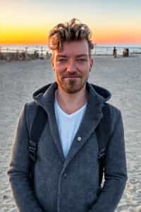 smiling masculine  man enjoying a sunset at a beach or park