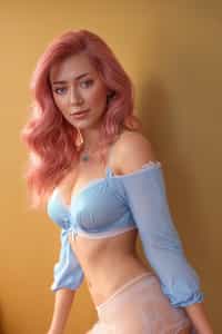 lingerie woman masterpiece, best quality, (photorealism), reflections, lingerie, extremely detailed, extremely detailed CG unity 8k wallpaper, cinematic lighting, detailed background, lingerie, 1girl, solo, medium hair, (pink hair), shirt, skirt, detailed clothes, blue skirt, blue shirt, detached sleeves, white shirt, bangs, (blue eyes, detailed eyes), choker, ribbon earrings, detached sleeves, lookng at the viewer, from below,, wait, bedroom