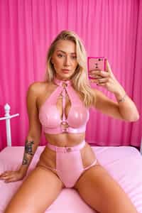 woman in a pink pvc latex lingerie sitting on a bed, heaven pink, hot pink, pink body harness, pink body, pink and black, hot pink and black, olivia kemp, pink background, pink, skye meaker, ellie victoria gale, 🤬 🤮 💕 🎀, casey cooke, posing in a bedroom, laica chrose, wearing a pink head band
