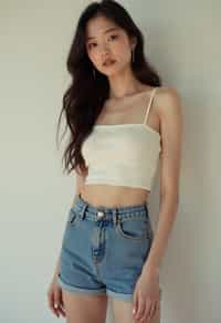 woman wearing crop top and denim shorts  in try on fashion shoot for Zara Shein H&M