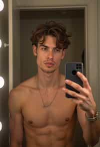 beautiful man taking a selfie in bathroom mirror