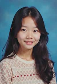 (school portrait) photo headshot of a young 18 y o woman in 1990s style, nineties style, 90s, 1990s fashion, 1990s hair, school, woman is sitting and posing for a (yearbook) picture, blue yearbook background, official school yearbook photo, woman sitting (looking straight into camera), (school shoot), (inside), blue yearbook background