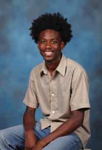 (school portrait) photo headshot of a young 18 y o man in 1990s style, nineties style, 90s, 1990s fashion, 1990s hair, school, man is sitting and posing for a (yearbook) picture, blue yearbook background, official school yearbook photo, man sitting (looking straight into camera), (school shoot), (inside), blue yearbook background