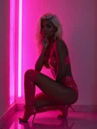 kneeling woman as woman, pink latex, thigh high boots night club, neon lights, platinum blonde