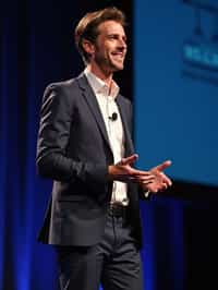 man as a conference keynote speaker standing on stage at a conference