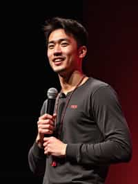 TedX speaker man holding microphone with lanyard around his neck