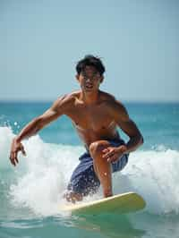 man as a Professional Surfer wearing swimwear on a Surf Board surfing in the ocean