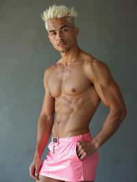 man as with platinum blonde hair and pink latex skirt