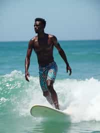 man as a Professional Surfer wearing swimwear on a Surf Board surfing in the ocean