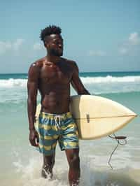 man in  board shorts with surfboard on the beach, ready to ride the waves