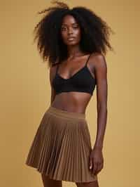 woman wearing crop top and short pleated skirt  in try on fashion shoot for Zara Shein H&M