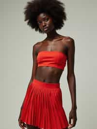 woman wearing crop top and short pleated skirt  in try on fashion shoot for Zara Shein H&M