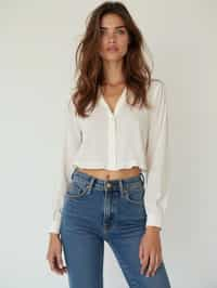 woman wearing white cropped blouse and denim jeans  in try on fashion shoot for Zara Shein H&M