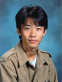 (school portrait) photo headshot of a young 18 y o man in 1990s style, nineties style, 90s, 1990s fashion, 1990s hair, school, man is sitting and posing for a (yearbook) picture, blue yearbook background, official school yearbook photo, man sitting (looking straight into camera), (school shoot), (inside), blue yearbook background