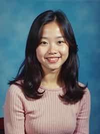 (school portrait) photo headshot of a young 18 y o woman in 1990s style, nineties style, 90s, 1990s fashion, 1990s hair, school, woman is sitting and posing for a (yearbook) picture, blue yearbook background, official school yearbook photo, woman sitting (looking straight into camera), (school shoot), (inside), blue yearbook background