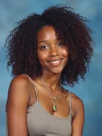 (school portrait) photo headshot of a young 18 y o woman in 1990s style, nineties style, 90s, 1990s fashion, 1990s hair, school, woman is sitting and posing for a (yearbook) picture, blue yearbook background, official school yearbook photo, woman sitting (looking straight into camera), (school shoot), (inside), blue yearbook background